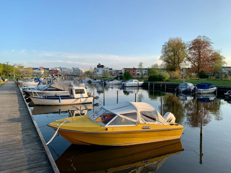 white and brown boat on water during daytime